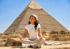 Visitor sitting in front of a Giza pyramid